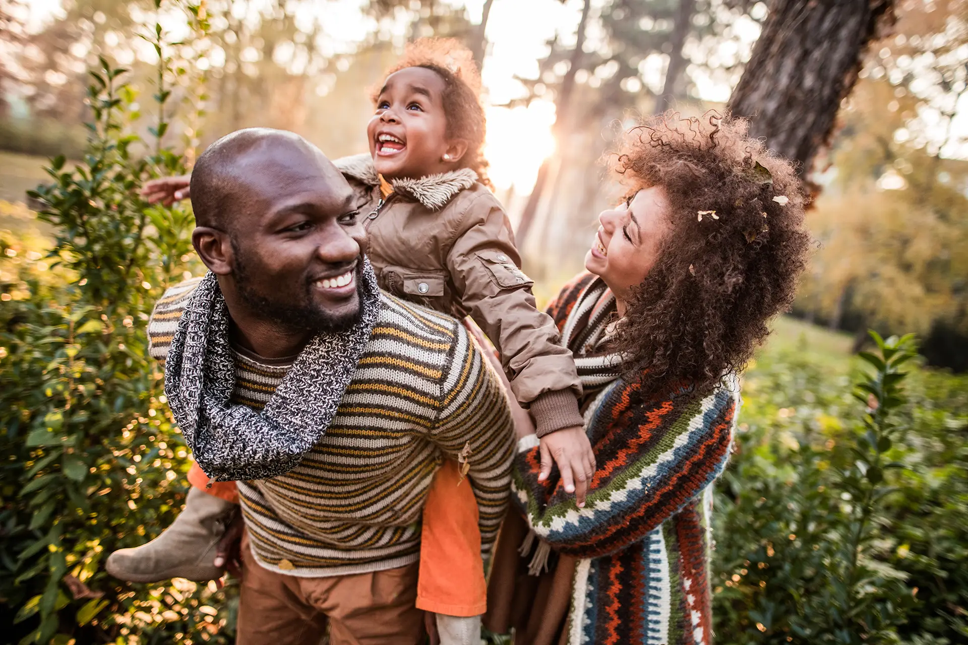 Husband and wife with child in woods